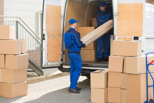 Furniture pick-up team loading a sofa in North Harrow