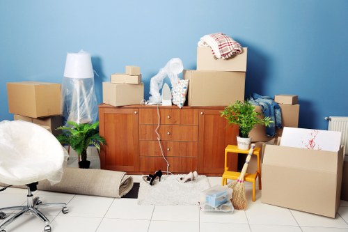 Removalists carrying furniture from a North Harrow flat or house