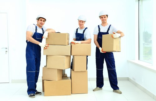 Local movers handling furniture in a North Harrow residential street